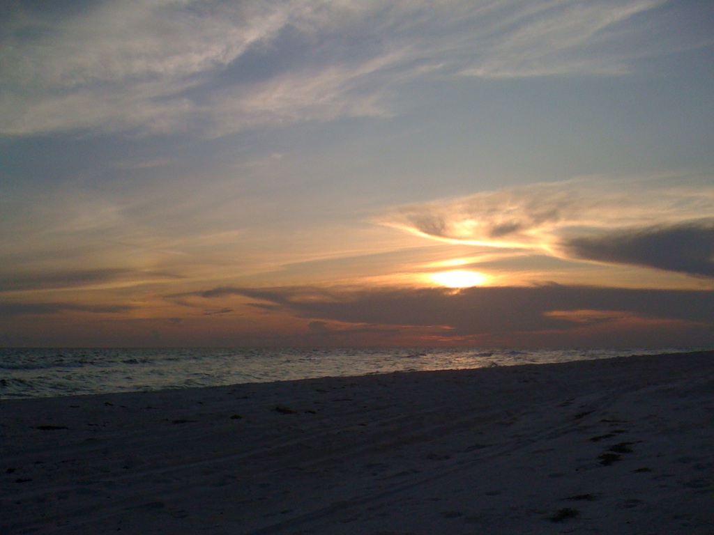 evening ocean front beach view with the sun setting
