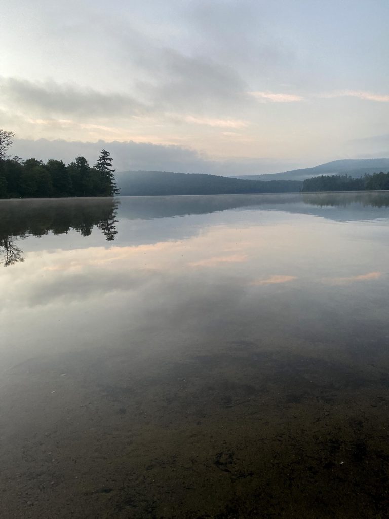 Limekiln lake with tree line and mountains in the background